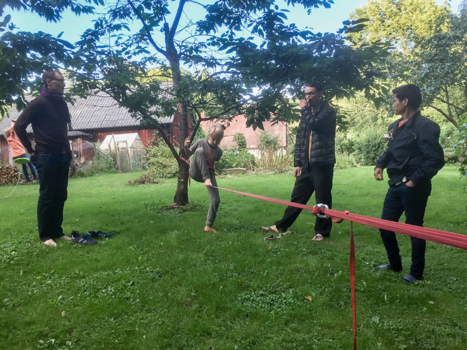 Familjen går på lina i trädgården