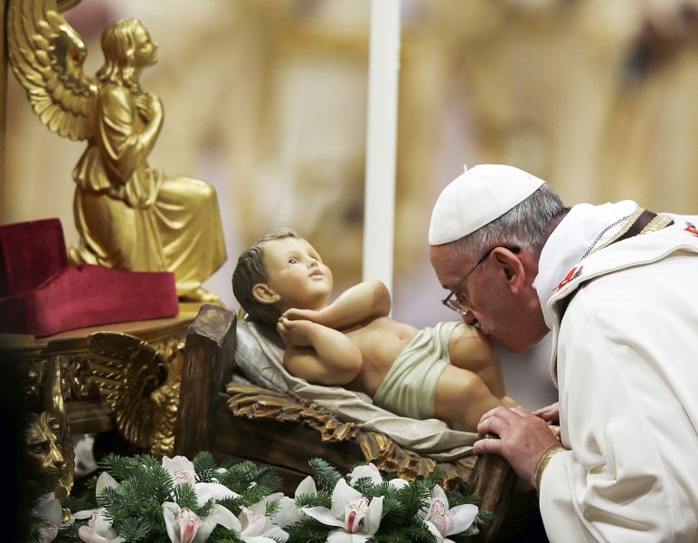 Gregorio Borgia/AP/TT | Påven kysser Jesusbarnet under en julceremoni i Vatikanstaten.