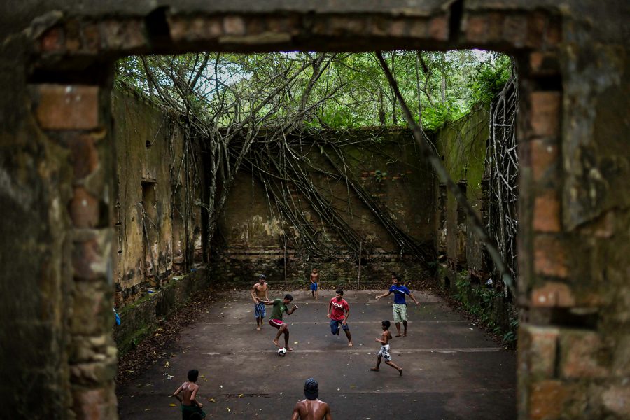 Felipe Dana /AP/TT | Barn och vuxna spelar fotboll i ruinerna av Paricatuba i Amazonas.
