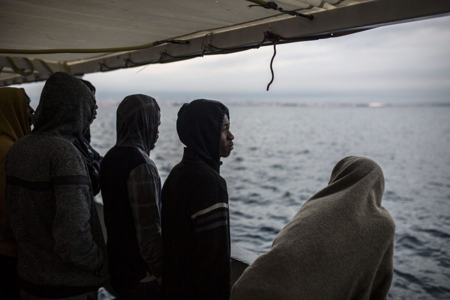 På bilden syns räddade migranter ombord på fartyget Open Arms.