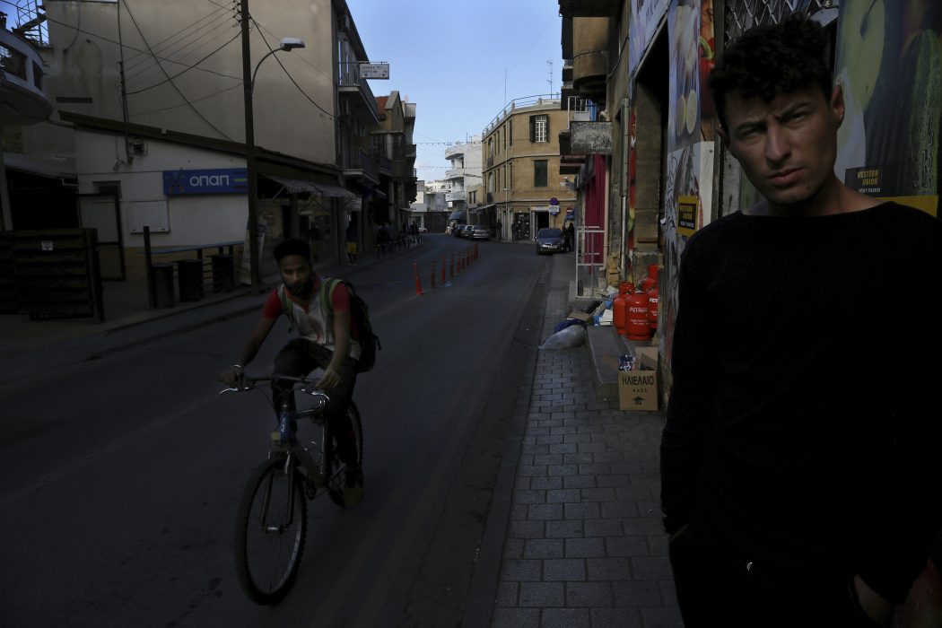In this Friday, Nov. 16, 2018 a homeless migrant stands on a street in central Nicosia, Cyprus. Cyprus was not seen as an attractive destination for migrants seeking shelter and a new life in Europe, but that has changed as other nations in Europe have shut their borders and the economic situation has slowly improved for this small island nation. (AP Photo/Petros Karadjias)
