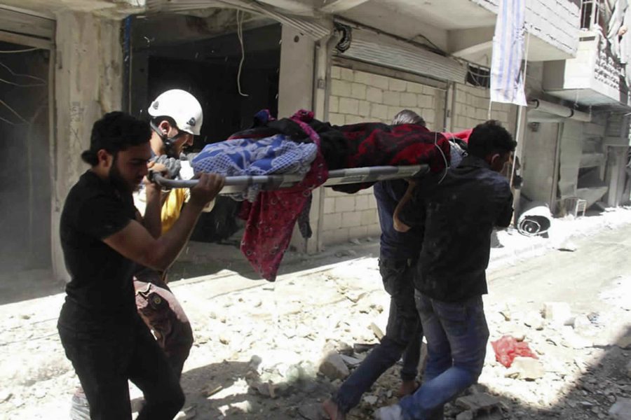En man bärs mot ambulans på en bår strax efter ett flyganfall i staden Ariha i Idlib den 27 maj i år.