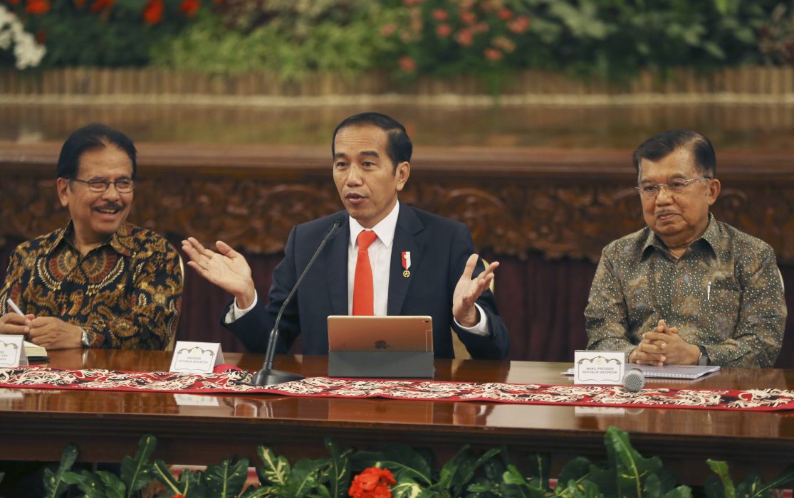 Indonesia President Joko Widodo, center, speaks as his deputy Jusuf Kalla, right, and Minister of Agrarian and Spatial Planning Sofyan Djalil, left, looks on during a press conference at the palace in Jakarta, Indonesia, Monday, Aug. 26, 2019. Indonesia's president has announced to relocate the country's capital from overcrowded, sinking and polluted Jakarta to East Kalimantan province. (AP Photo/Achmad Ibrahim) XAI103