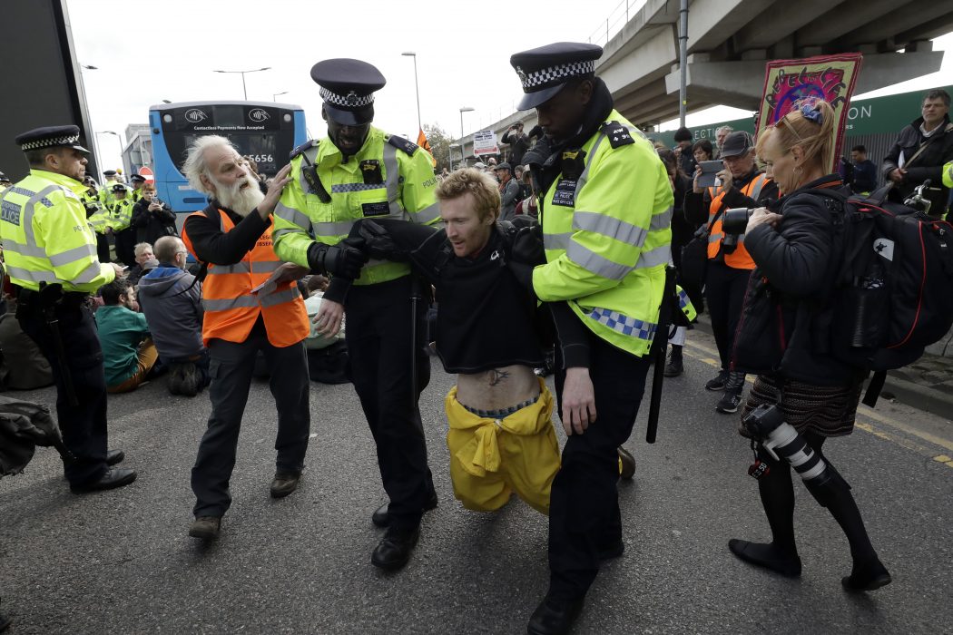 En person dras bort från en plats där han varit med och blockerat en väg vid London City Airport.
