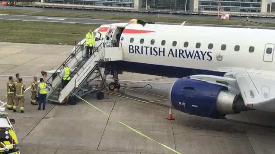 Paralympiern James Brown klättrade upp på ett British Airways flygplan vid City Airport, London, och klistrade fast sig själv på taket.