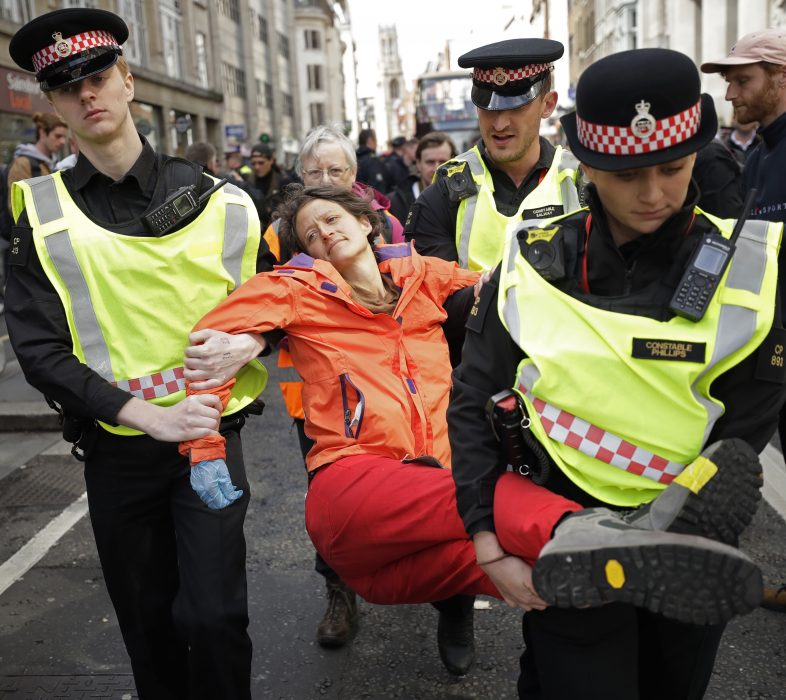 En demonstrant bärs bort sedan hon blockerat trafiken utanför Goldman Sachs i London den 25 april i år.