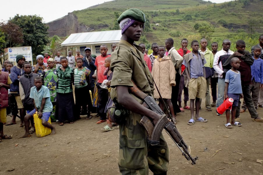 Invånare i orten Bunagana, i norra Kivu, står framför en rebellsoldat som varit med och tagit kontroll där, i juli 2012.