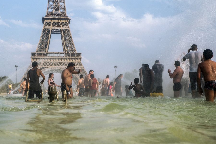People cool down in the fountains of the Trocadero gardens in Paris, Thursday July 25, 2019, when a new all-time high temperature of 42.
