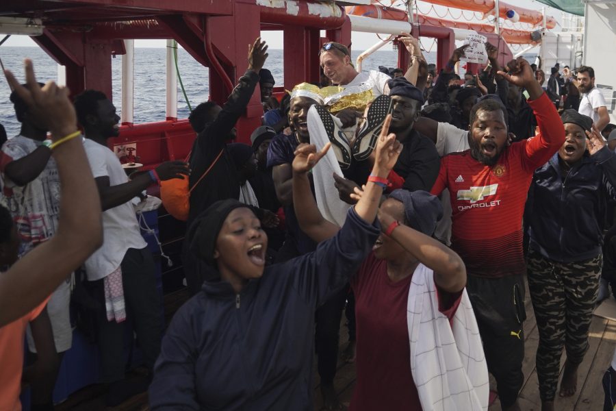Bild från i september, när flyktingar som räddats ombord på Ocean Viking firar att Italien sagt att fartyget får lägga till där.
