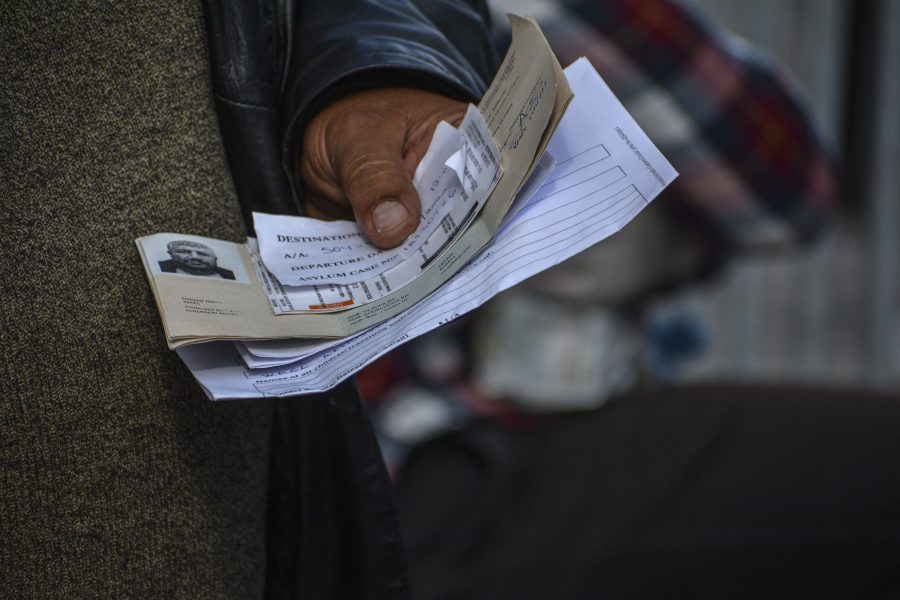 En man håller fram sina dokument för att få resa från ön Lesbos till hamnstaden Piraeus på fastlandet.