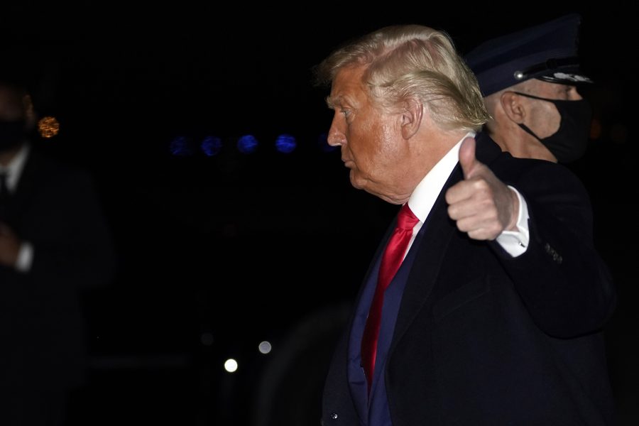 President Donald Trump gör tummen upp när han landar i huvudstaden efter måndagens kampanjmöten i Pennsylvania.