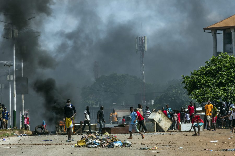 Anhängare till oppositionsledaren Cellou Dalein Diallo kastar sten mot polisen i Guineas huvudstad Conakry.