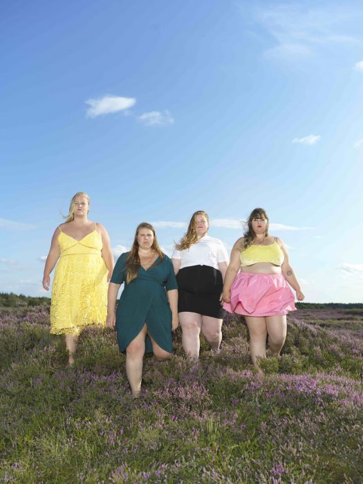Kroppsaktivisten Pauline Lindborg i gul klänning, tillsammans med de andra medverkande i filmen Fat front