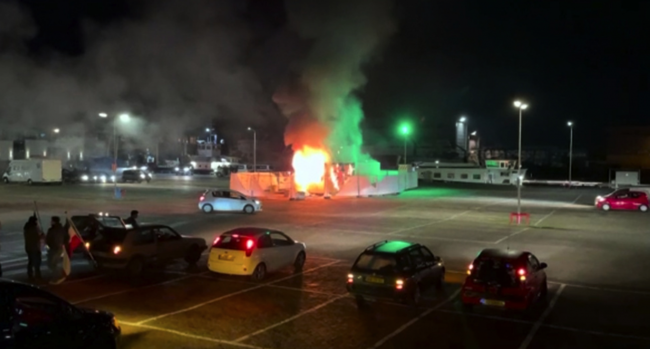 I den här bilden, tagen ur ett videoklipp, syns ett covidtestcenter som stuckits i brand i Urk, åtta mil nordöst om Amsterdam.
