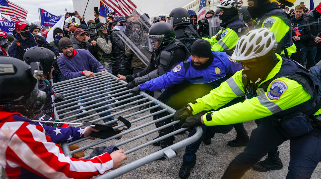 Trump-anhängare och polis i våldsam dragkamp under oroligheterna vid kongressen i Washington.