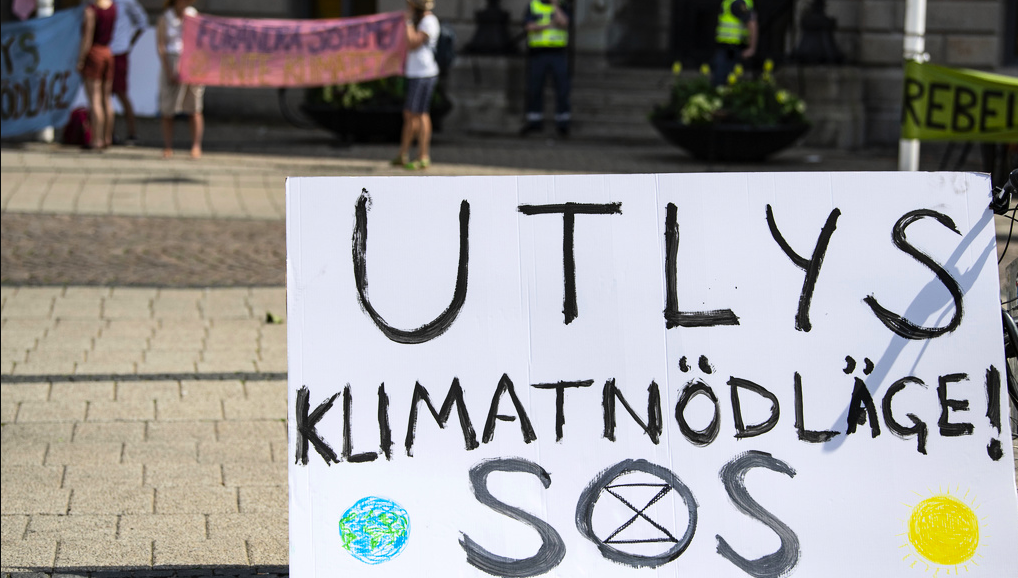 Aktivister från Extinction Rebellion demonstrerar utanför Rådhuset i Malmö då stadens politiker anländer för kommunfullmäktigemöte.