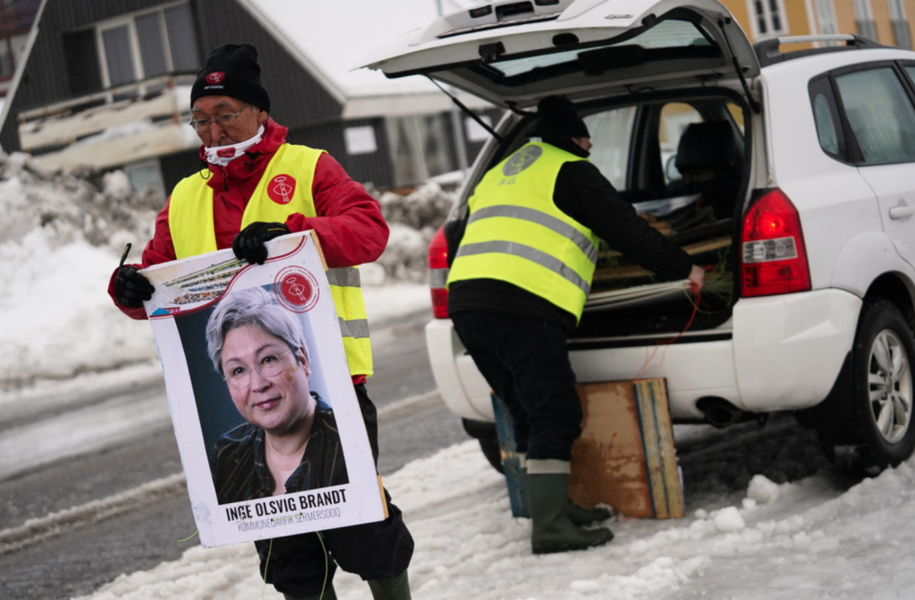 Volontärarbetare för partiet Inuit Ataqatigiit (IA) förbereder kampanjskyltar i Nuuk, Grönland.