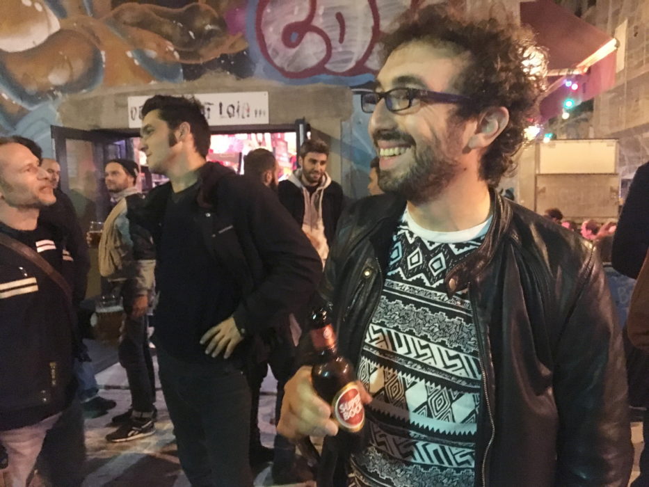 Michel Allouche (till höger) har sedan länge bokat in att tillbringa sin onsdagskväll på favoritbaren Demain c'est loin i östra Paris.