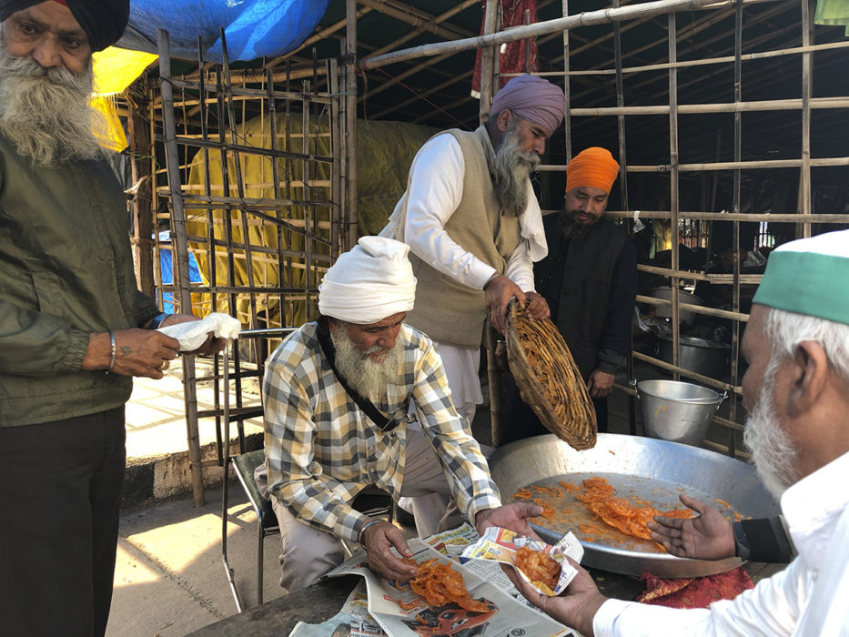 Godsaker delas ut för att fira Modis besked i Ghazipur i Delhi på fredagen.