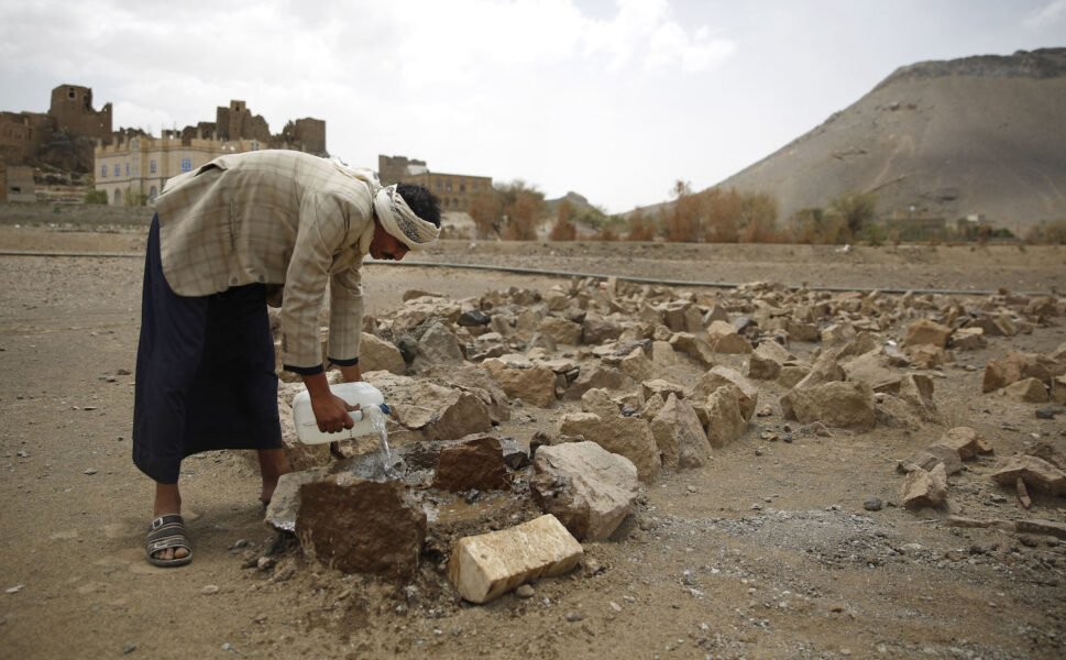 Jemeniten Faisal Ahmed häller vatten på sin sons grav i utkanten av Sanaa.
