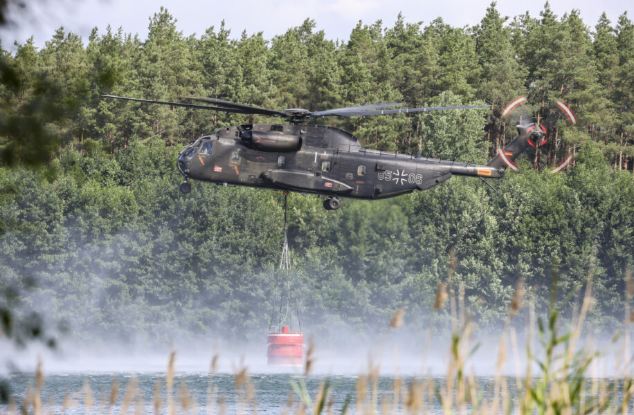 En arméhelikopter som satts in för att bekämpa en brand i Elbe-Elster i Tyskland fyller på vatten.