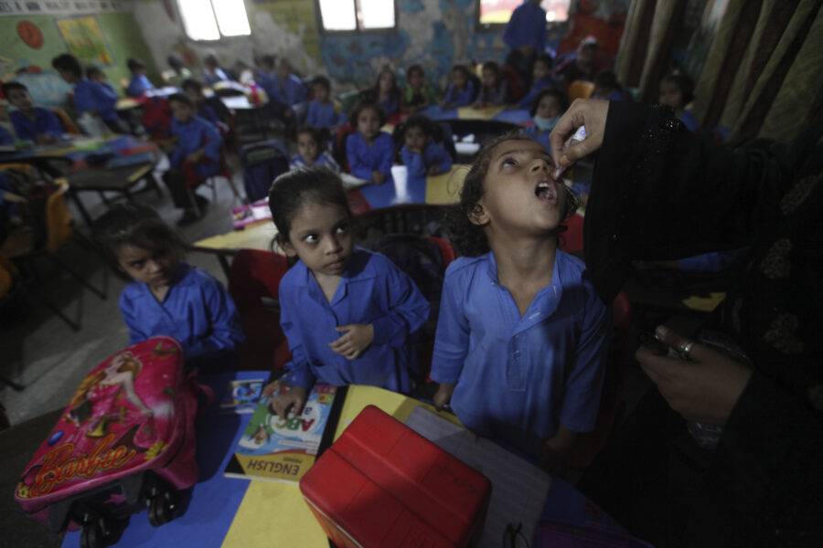 Skolbarn i Lahore, Pakistan, får poliovaccin som droppas i munnen.