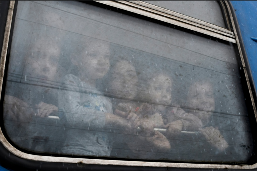 Barn tittar ut från ett tåg som är på väg att avgå från Kramatorsk i östra Ukraina.