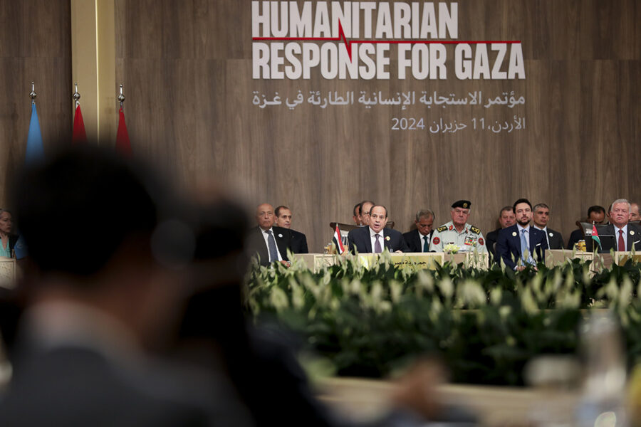 Humanitarian responde for Gaza, på vägg bakom män vid bord