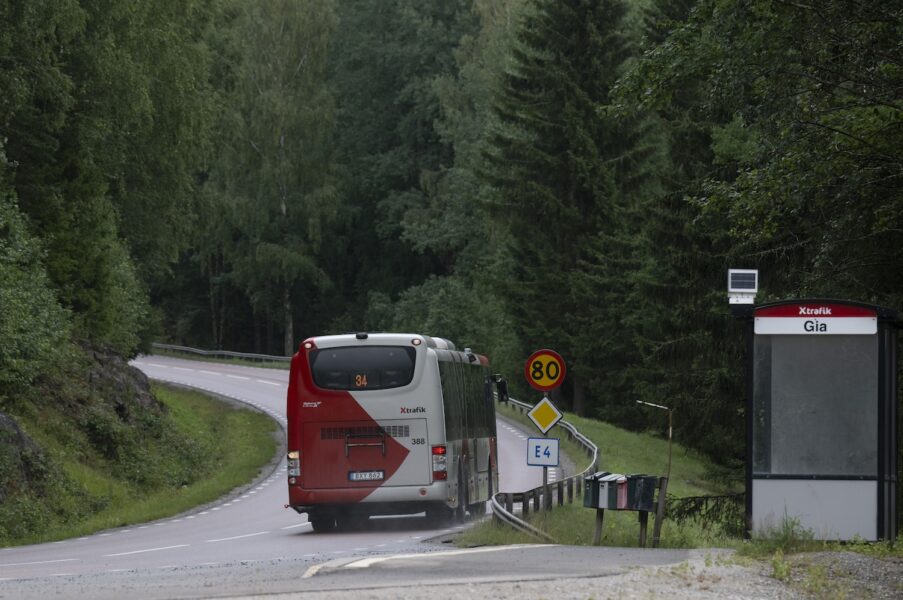 Buss vid busshållsplats på enslig väg på landet.