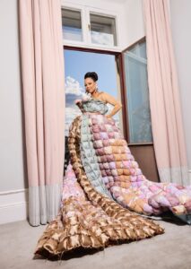 Alice Bah Kuhnke iförd en omfångsrik klänning i lapptäcksteknik.