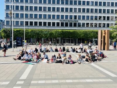 Demonstranter sitter ner i ring.