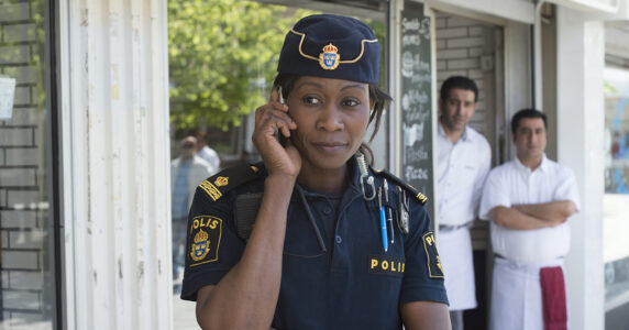 En polis talar i telefon.