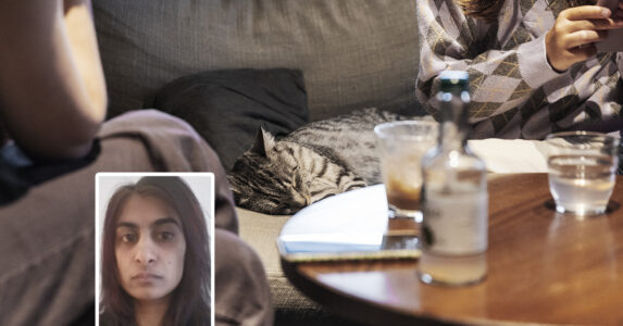 Två personer fikar med en katt.