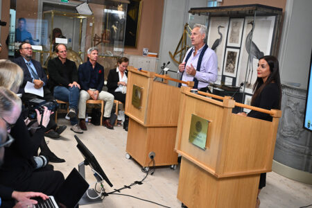 Kulturminister Parisa Liljestrand (M) tar emot slutbetänkandet ”En kulturkanon för Sverige” av kommitténs ordförande Lars Trägårdh vid en pressträff på Gustavianum i Uppsala.