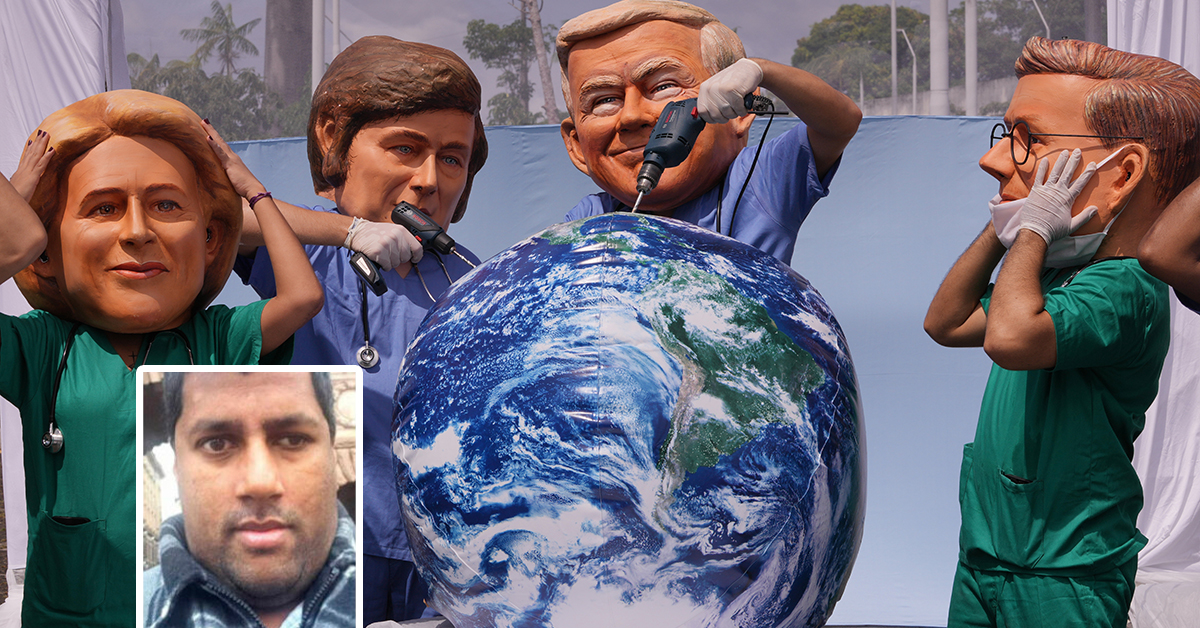 En demonstrant med Trump-mask borrar i en jordglobsboll,