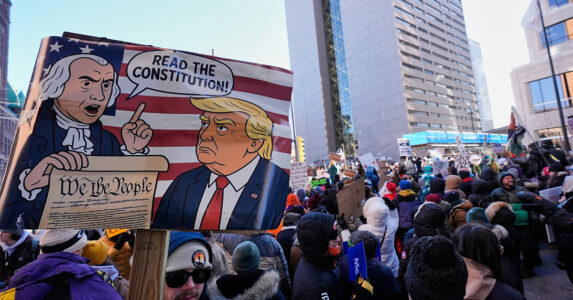 Demonstranter med en skylt där Trump uppmanas läsa konstitutionen.