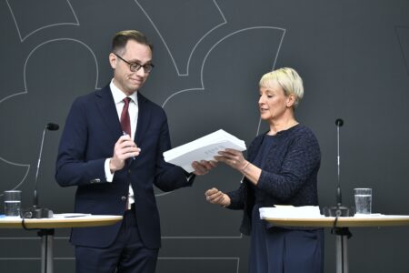 Anna Tenje (M)tar emot en utredning från utredare Mikael Westberg.